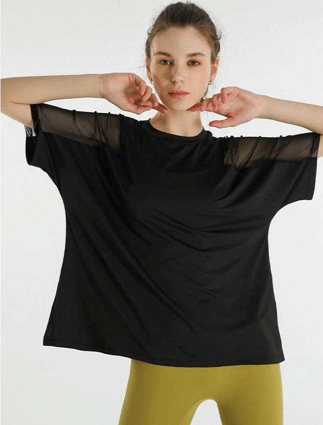 Woman wearing loose black running mesh t-shirt with short sleeves, perfect for workouts and sports activities like running and cycling.